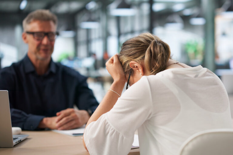 Two Office Workers Discuss Hiring Mistake During Tense Disciplinary Meeting.